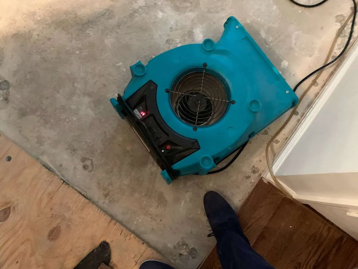 Air mover drying subfloor during Commercial Water Damage Restoration in Great Falls